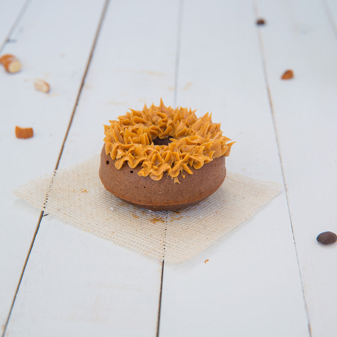 FITbelly Donut with a decorative top on a white wooden surface